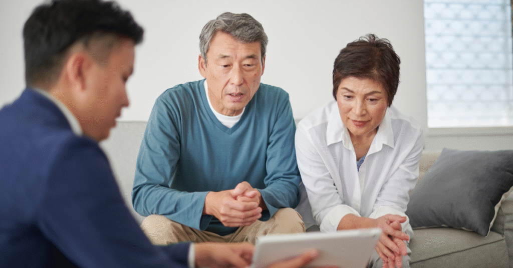 Reverse Mortgages: Why More Canadians Are Reconsidering This Once “Taboo” Option 5 Older Canadian couple reviewing reverse mortgage options at home with a financial professional, representing retirees rethinking home equity in 2025.