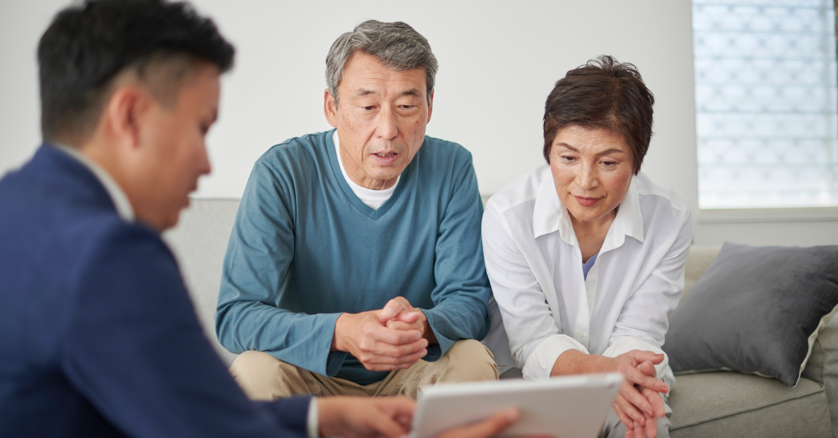 Older Canadian couple reviewing reverse mortgage options at home with a financial professional, representing retirees rethinking home equity in 2025.