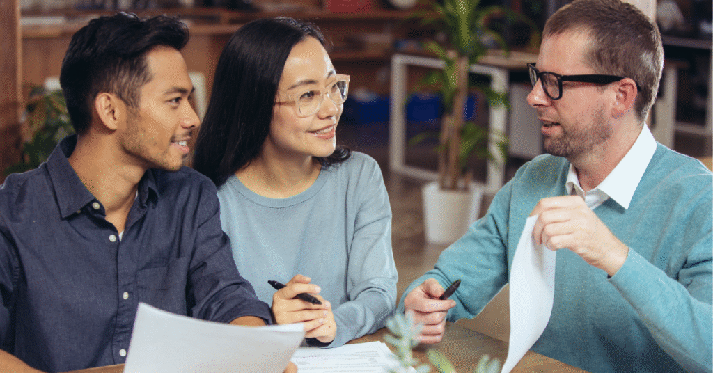 What Happens if I Can’t Repay My Home Equity Loan on Time? 8 Couples discussing with an advisor on what can't happen if they can't repay a home equity loan