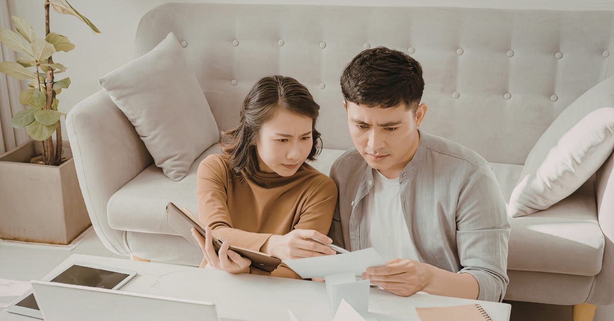 Couple checking mortgage guide for homeowners